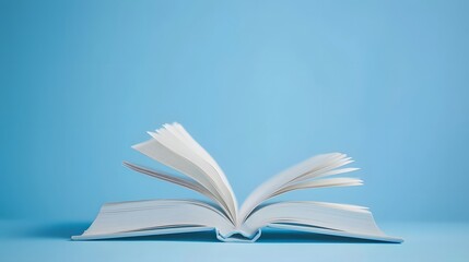 A book is open on the table, with a white, blurred background and soft light. The pages of the book show colorful text in a high-definition photography style.