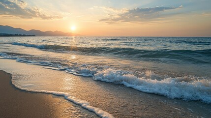 A serene beach at dawn with gentle waves and the sun just beginning to peek over the horizon