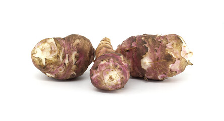 Fresh raw Jerusalem artichokes isolated against a white background