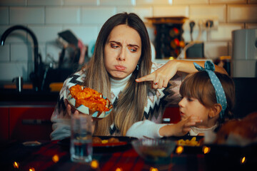 Annoying Mom Pointing to a Traditional Dish for Christmas Dinner. Picky eating child rejecting...