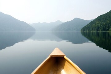 Obraz premium Tranquil Lake with Wooden Canoe Amidst Serene Mountain Landscape – Calming Nature
