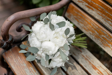 the bride's wedding bouquet is lying on a bench