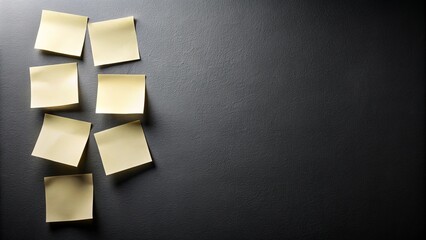 A minimalist arrangement of blank yellow adhesive notes on a textured black surface, creating a visually captivating backdrop for your ideas and reminders.