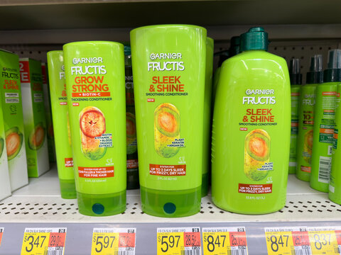 Garnier Fructis shampoo bottles on market shelf.