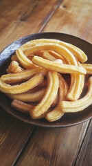 Plate of freshly fried golden churros on wooden table for traditional Spanish dessert concept