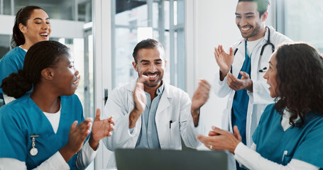 Group, doctor and laptop with applause in hospital for medical success, celebration and promotion...
