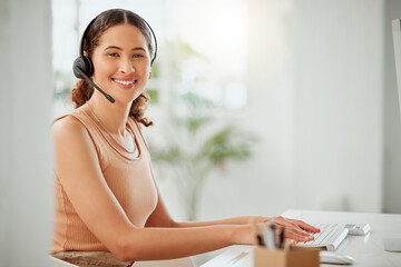 Obraz premium Woman, portrait and headset in office with smile, contact and happy for connectivity. Virtual assistant, business and typing at computer for innovation, email feedback and advice at help desk in Peru