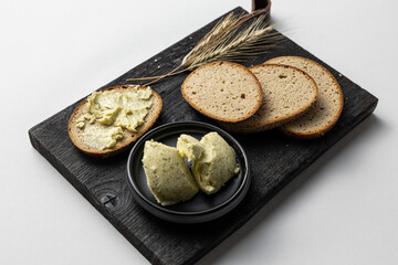 Rustic Bread with Herb Butter on dark Wooden Board white background