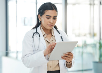 Woman, doctor and typing with tablet in hospital for healthcare schedule, planning surgery and Telehealth. Girl, digital and medical research with patient results, treatment advice and history report