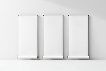 Three Blank White Roll-Up Banners Hanging on a Wall