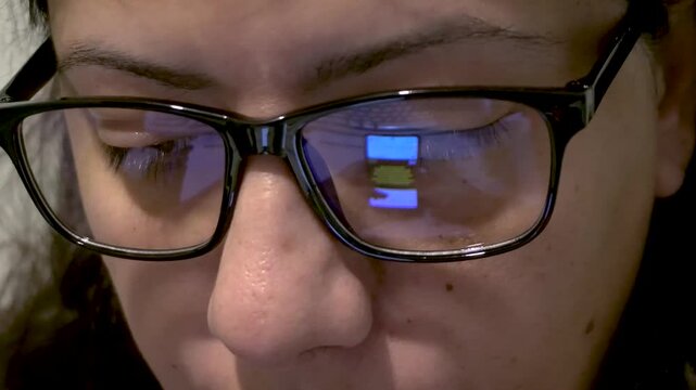 Woman Scrolling on Smartphone Social Media App, Mobile Phone Screen Reflecting on Her Glasses