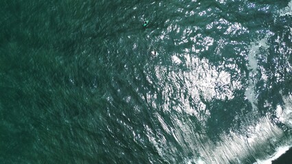 Summer seascape beautiful waves, blue sea water in sunny day. Top view from drone. Sea aerial surf, amazing tropical nature background. Mediterranean