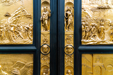 Golden door of baptistery near big cathedral in Florence