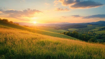 Obraz premium Scenic Sunset Over Green Hills and Fields