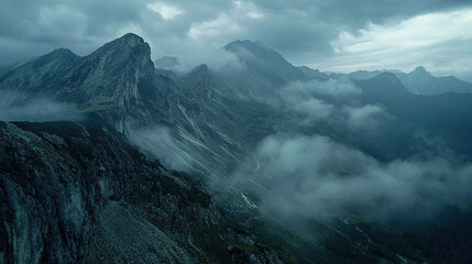 Obraz premium Aerial view of mountain peaks covered in mist