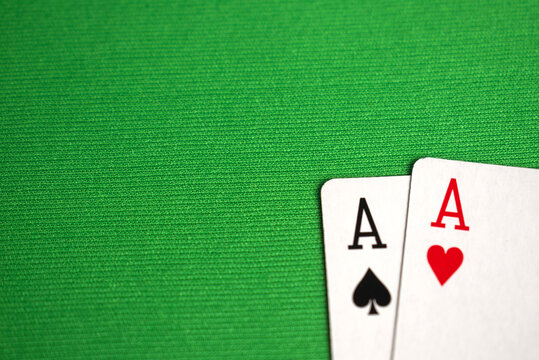 close up of two aces poker card on green table for background