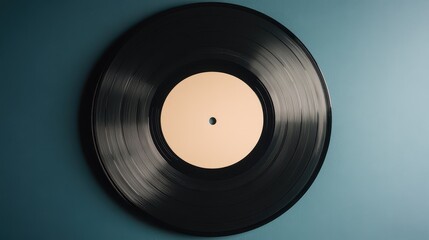 Obraz premium A classic black vinyl record on a blue background, showcasing timeless music culture and nostalgia.
