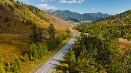 the car is driving along the Chuisky highway in Altai in autumn