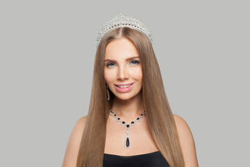 Charming glamorous jewellery woman wearing jewelry crown tiara with diamond posing against white...