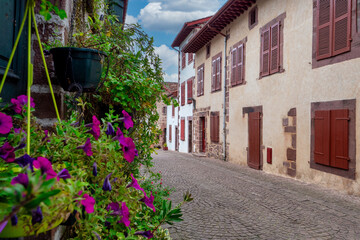 Saint Jean Pied de Port, street with a brick sidewalk and a row of houses.