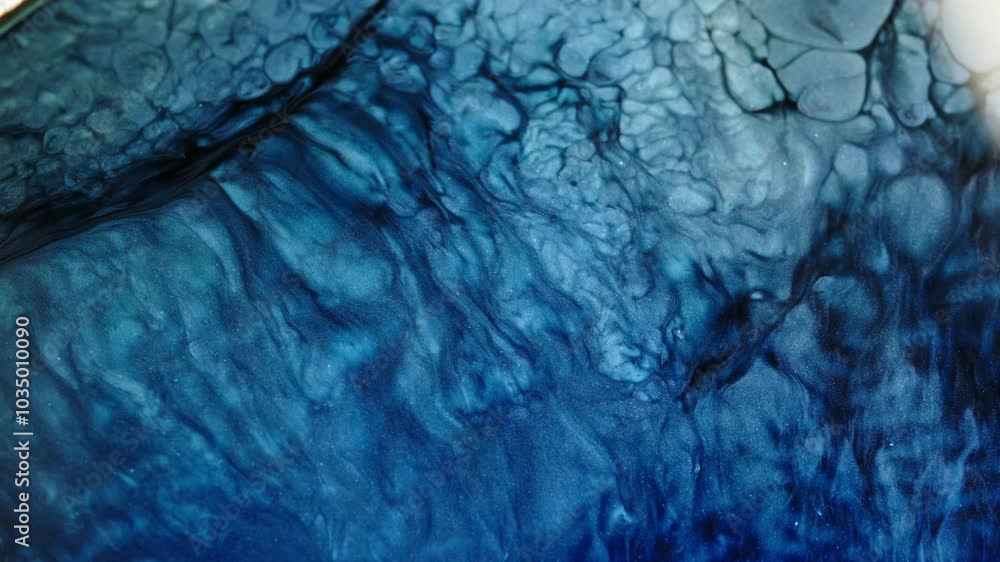 Poster vibrant blue liquid patterns swirl and mix in intricate macro detail, creating a dynamic abstract ef