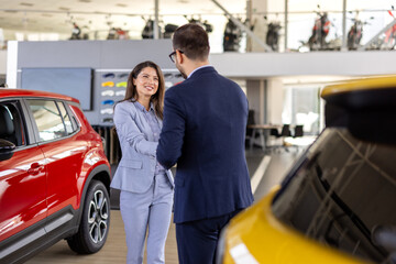 Car dealership, salesman or happy woman shaking hands for vehicle, finance agreement or purchase....