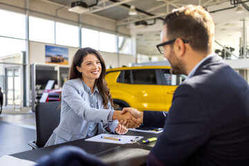 Car dealership, documents and people with handshake in showroom and contract, consulting and...