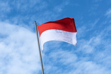 Indonesian Flag, Red and White, with blue sky background.