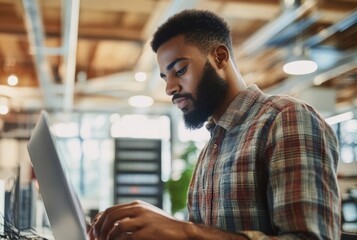 Technician in modern office maintaining network server, surrounded by cables and routers, showcasing focus and professionalism in IT infrastructure management.	