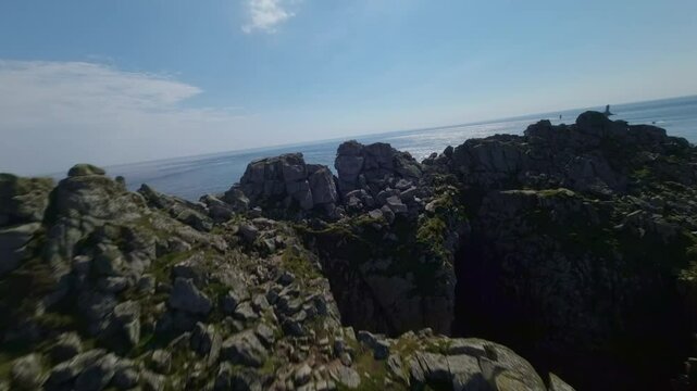 A Scenic View of the Rugged Pointe du Raz Promontory, Showcasing La Vieille Lighthouse, Located in Brittany, France - FPV Shot