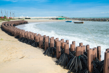 Artificial Wooden Poles Made from Discarded Plastic or recycle to Create Beach Wave Fence Lines for coastal erosion that capsule to Ocean sediment system .