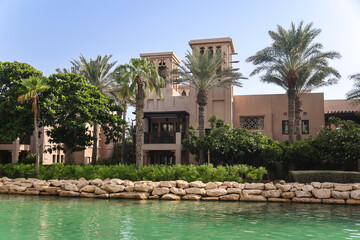 Beautiful city view of houses with water canal in the background in arab country.