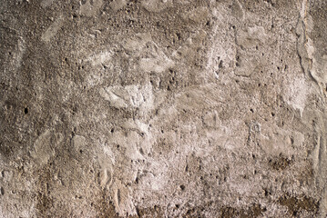 The photo shows an old brown concrete wall
