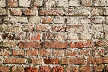 The photo shows an old brown brick wall
