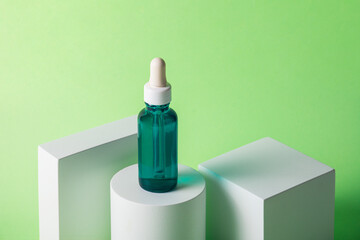 Blue sunscreen bottle on green background. Sunscreen concept. Skin care concept. Copy space.