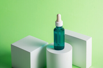 Blue sunscreen bottle on green background. Sunscreen concept. Skin care concept. Copy space.