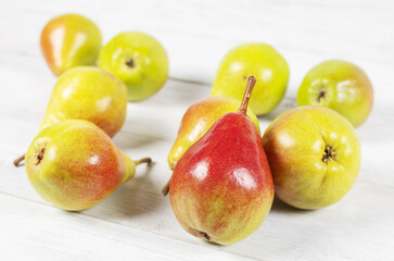 Pears on white wooden background