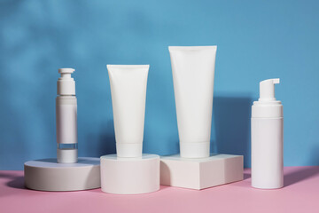 cosmetic tube and bottle on geometric pedestal podium, product packaging with natural shadows from plants