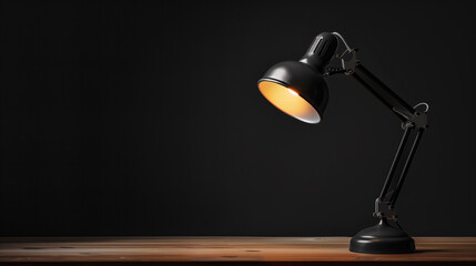 desk lamp on black dark background with space for text warm light