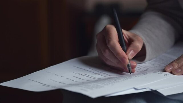 Female freelancer doing paperwork in home office interior, 4K