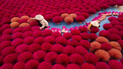 Aerial view of a colorful incense field with traditional workers, Huyen Ung Hoa, Vietnam.