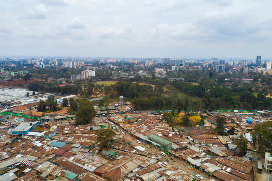 Aerial view of the dense urban landscape of Kibera slum with crowded rooftops and buildings, Nairobi, Kenya.