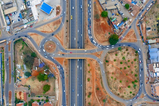 Aerial view of busy Thika Road intersection with modern buildings and dynamic traffic, Kasarani, Nairobi, Kenya.