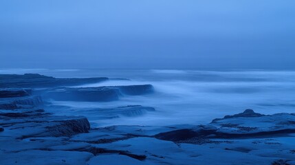 Fototapeta premium Tranquil Coastal Scene at Dawn with Soft Waves