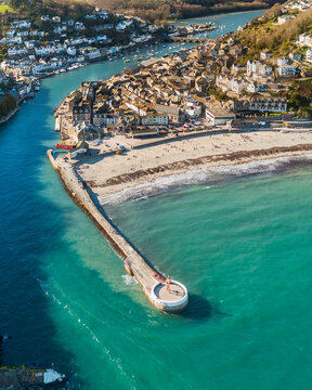 Aerial view of beautiful Looe Harbour with scenic coastline and vibrant beach, Looe, England.