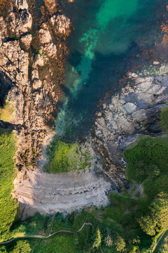 Aerial view of combe haven beach with a swimmer, fowey, england.