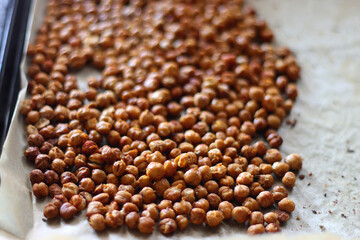 Sheet pan with homemade roasted chickpeas. Selective focus.