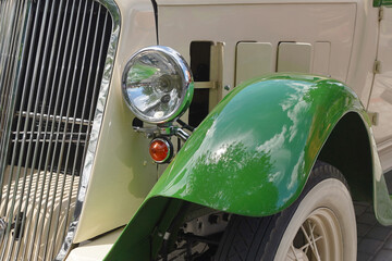 Vintage car front detail with green fender
