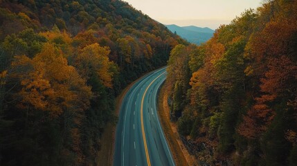 Fototapeta premium Scenic Autumn Road Through Vibrant Forest Landscape