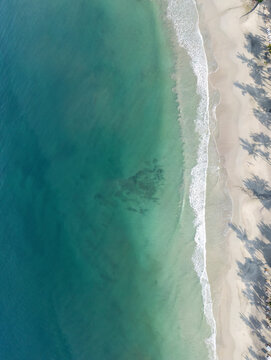 Aerial view of pristine turquoise beach and serene ocean waves, Punta Mita, Mexico.